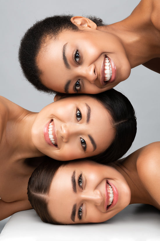 Three Diverse Girls Posing Together Smiling On Gray Background, Vertical stock photo